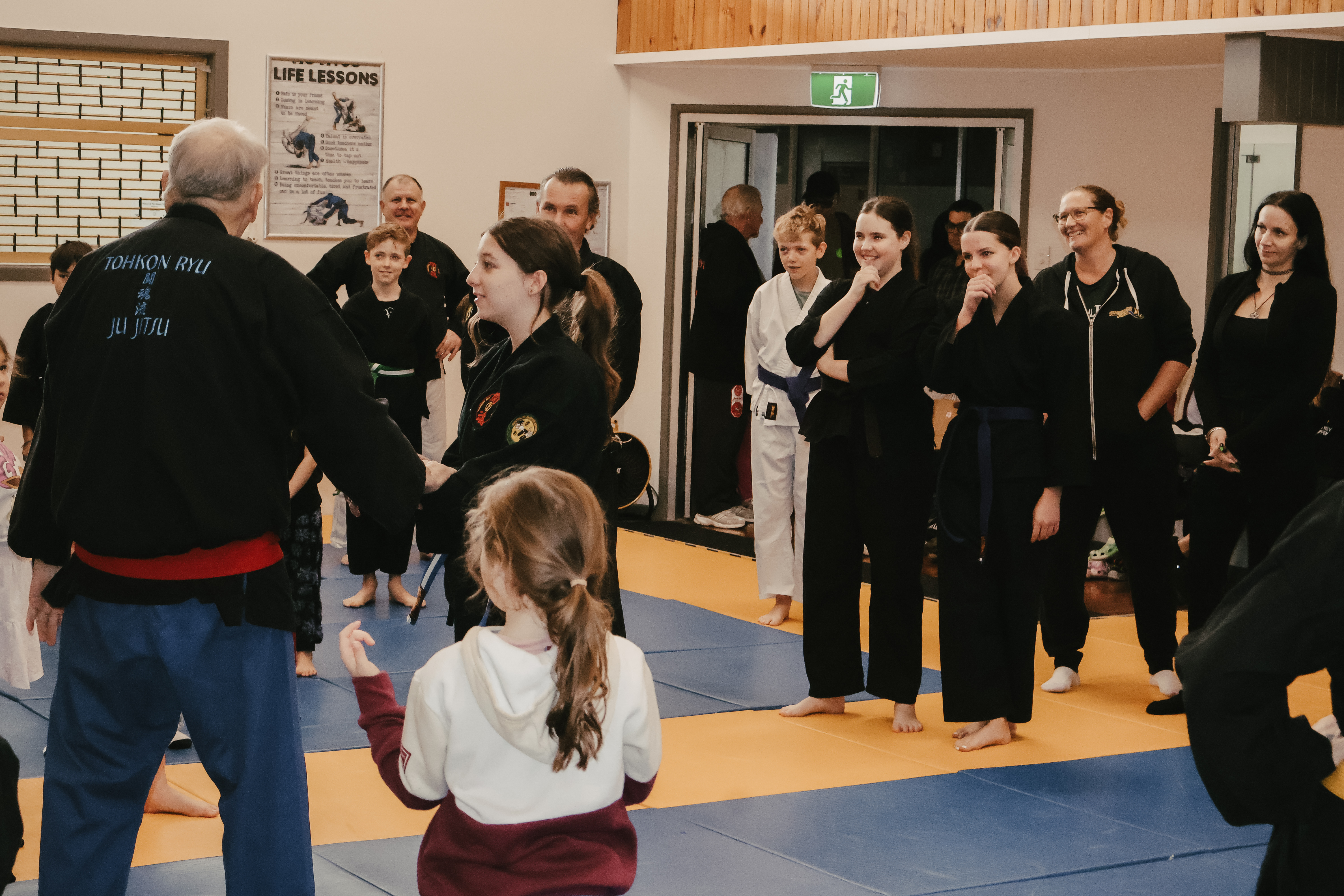 Kids Ju Jitsu class at Tohkon Ryu, Ipswich. Shihan Mark holding a pad as a young student kicks
